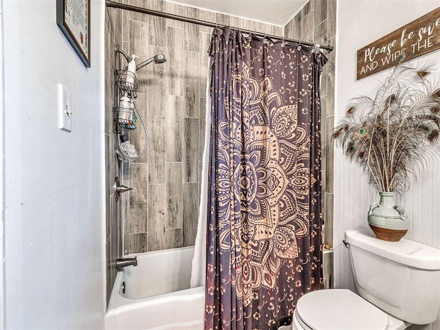 bathroom with shower / tub combo and toilet