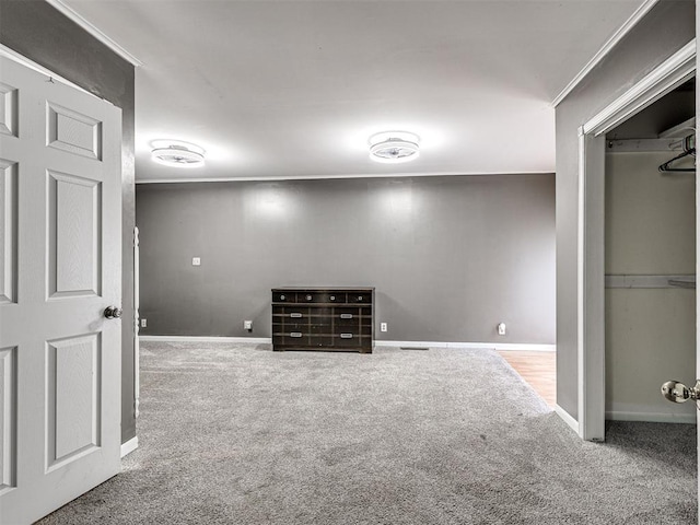 unfurnished bedroom featuring ornamental molding, carpet flooring, and a closet