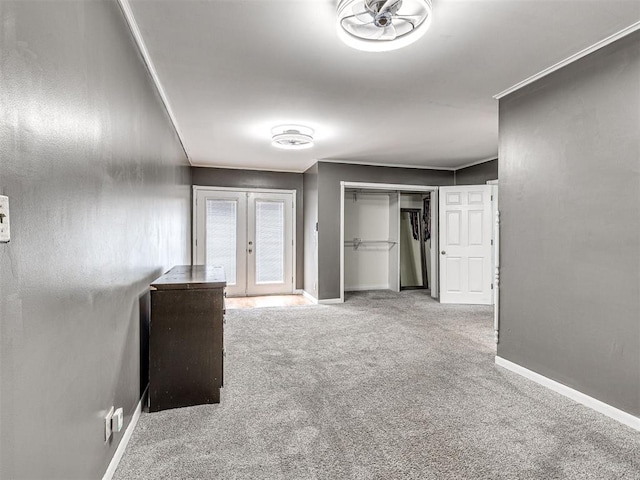 interior space featuring french doors, light colored carpet, and crown molding