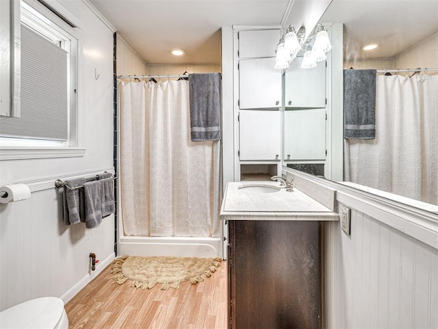 bathroom featuring walk in shower, vanity, toilet, and hardwood / wood-style floors