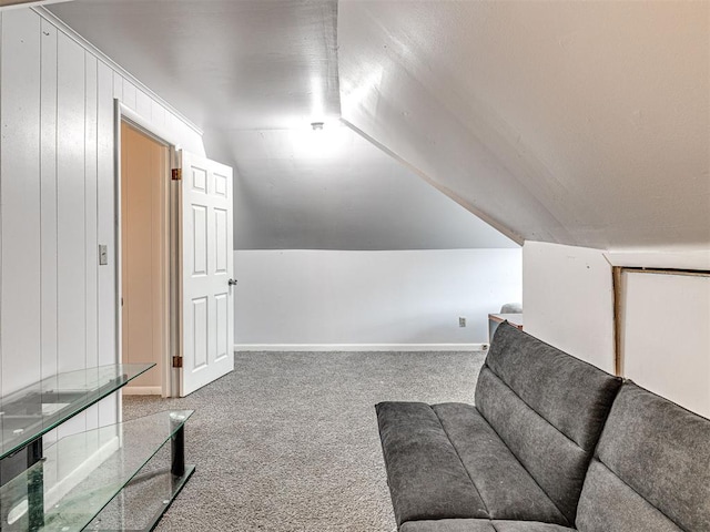 interior space featuring carpet flooring and vaulted ceiling