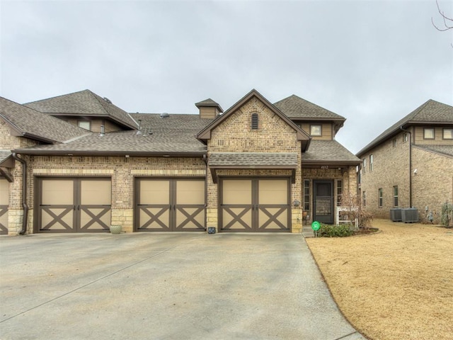 view of front of house featuring central AC and a garage