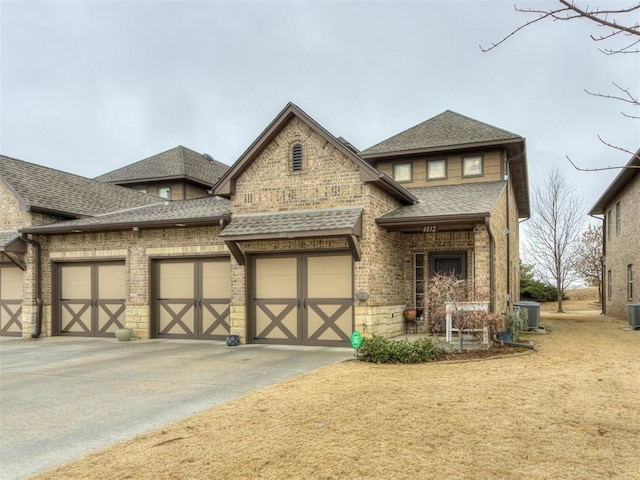 view of front of house featuring a garage and central air condition unit