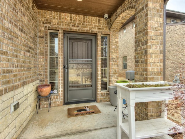 view of exterior entry featuring central AC unit