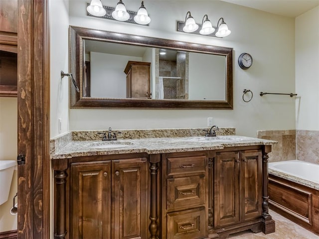 bathroom with vanity and a washtub