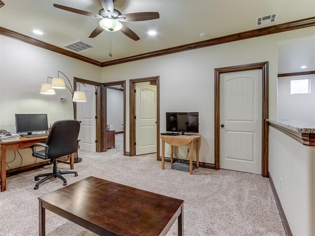 office area with ornamental molding, light colored carpet, and ceiling fan