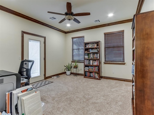 carpeted office space featuring crown molding and ceiling fan