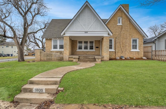 view of front of home with covered porch and a front yard