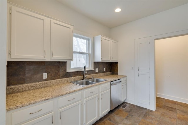 kitchen with sink, decorative backsplash, stainless steel dishwasher, and white cabinets