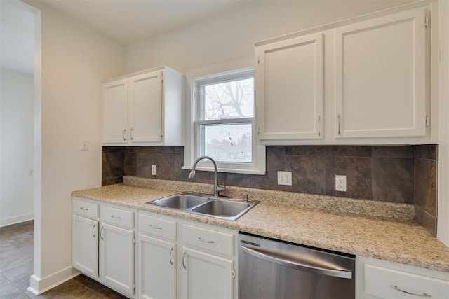 kitchen featuring white cabinetry, dishwasher, sink, and decorative backsplash