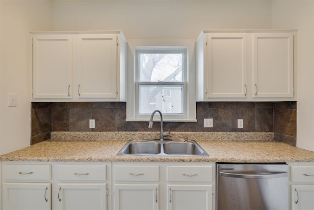 kitchen with white cabinetry, sink, decorative backsplash, and stainless steel dishwasher