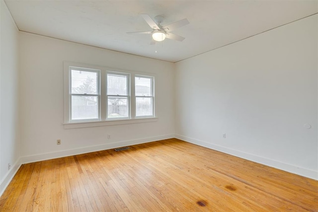 spare room with ceiling fan and light wood-type flooring