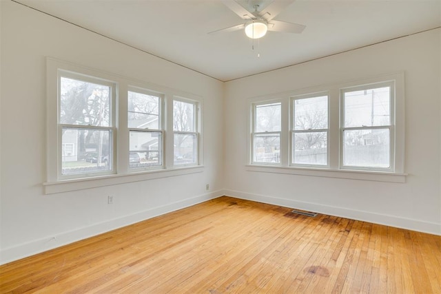 empty room with ceiling fan and light wood-type flooring