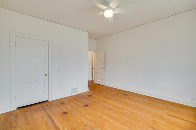 empty room with hardwood / wood-style floors and ceiling fan