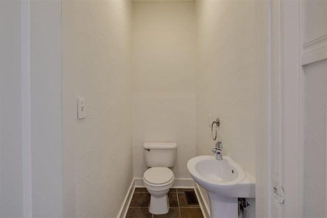 bathroom with tile patterned flooring, sink, and toilet