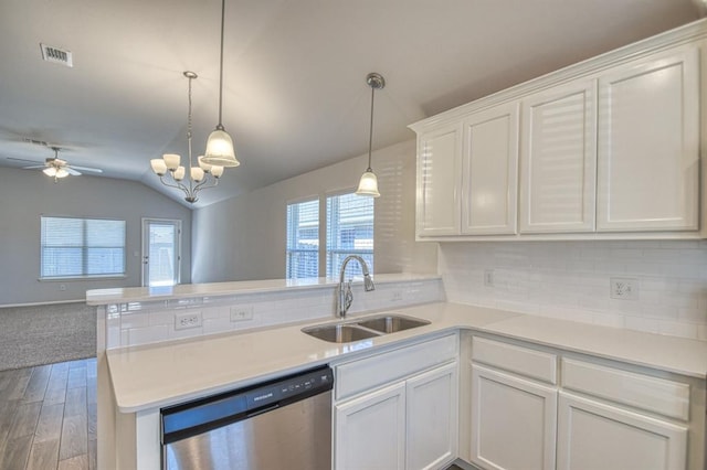 kitchen with a peninsula, a sink, white cabinetry, open floor plan, and dishwasher