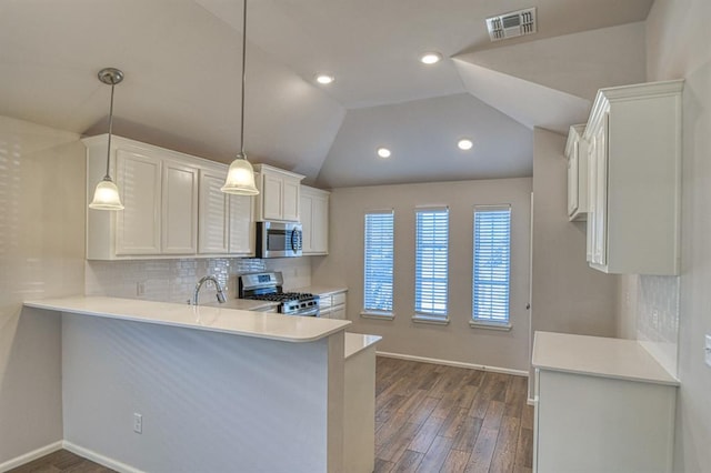 kitchen with stainless steel appliances, tasteful backsplash, light countertops, visible vents, and vaulted ceiling