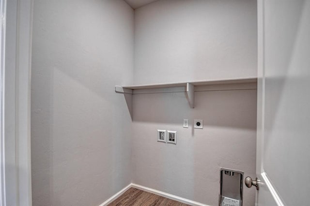 clothes washing area featuring hookup for an electric dryer, laundry area, washer hookup, wood finished floors, and baseboards