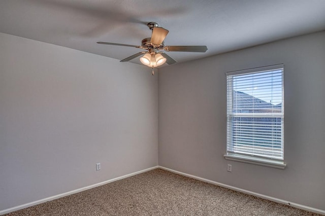 empty room with light colored carpet, ceiling fan, and baseboards