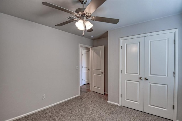 unfurnished bedroom featuring ceiling fan, carpet floors, a closet, and baseboards