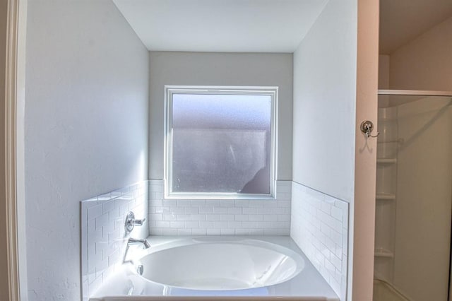 bathroom with a garden tub