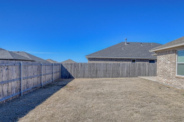 view of yard with a patio and a fenced backyard