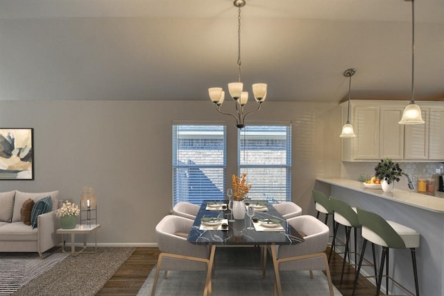 dining space with lofted ceiling, baseboards, a chandelier, and dark wood-style flooring