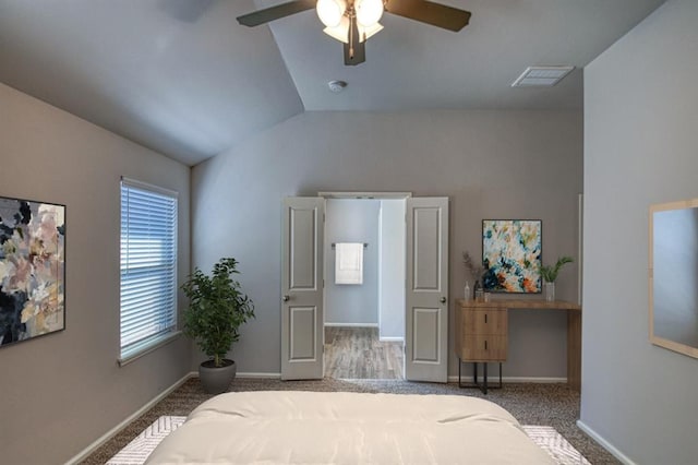 bedroom featuring carpet, visible vents, vaulted ceiling, ceiling fan, and baseboards