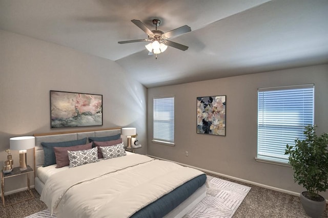 carpeted bedroom with a ceiling fan, vaulted ceiling, and baseboards