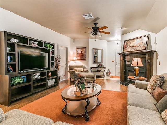 living room featuring hardwood / wood-style floors, vaulted ceiling, and ceiling fan