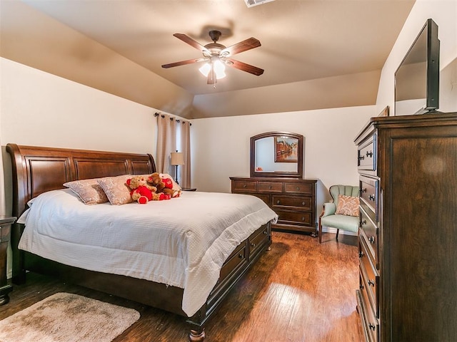 bedroom with dark hardwood / wood-style flooring, lofted ceiling, and ceiling fan