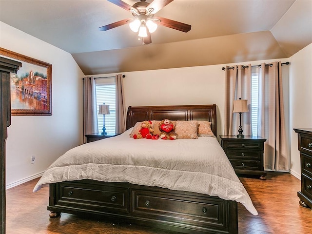 bedroom with dark wood-type flooring, ceiling fan, and lofted ceiling