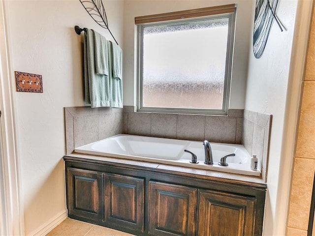 bathroom with tile patterned flooring, plenty of natural light, and a tub