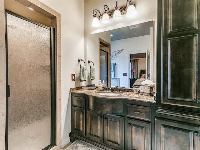 bathroom with walk in shower and vanity