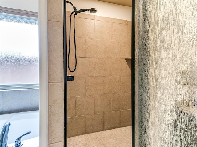 bathroom featuring shower with separate bathtub