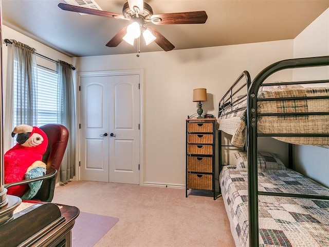 bedroom with light colored carpet and ceiling fan