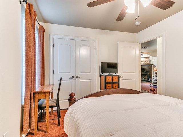 bedroom featuring carpet, ceiling fan, and a closet