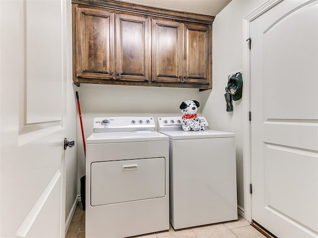 laundry area featuring washer and dryer and cabinets