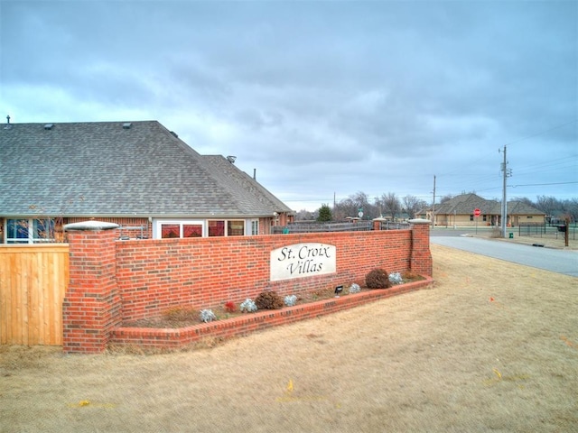 community / neighborhood sign featuring a yard