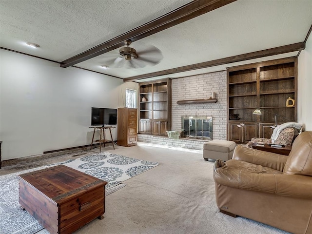 living room with built in features, beam ceiling, a fireplace, carpet flooring, and a textured ceiling