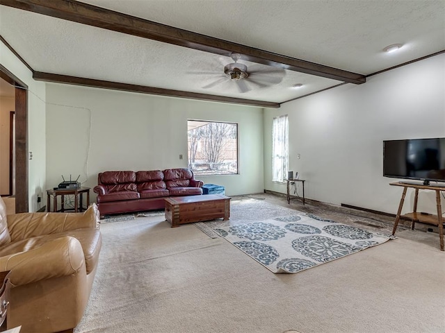 carpeted living area with beam ceiling, ceiling fan, a textured ceiling, and baseboards