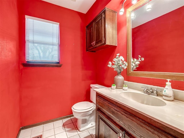 half bath with toilet, tile patterned flooring, and vanity