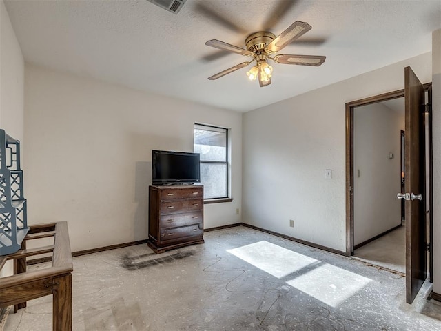 interior space featuring visible vents, baseboards, ceiling fan, and a textured ceiling