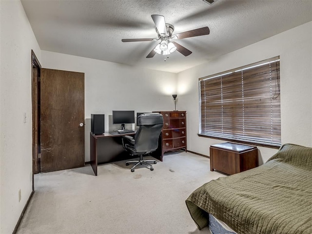 carpeted bedroom with baseboards, a ceiling fan, and a textured ceiling