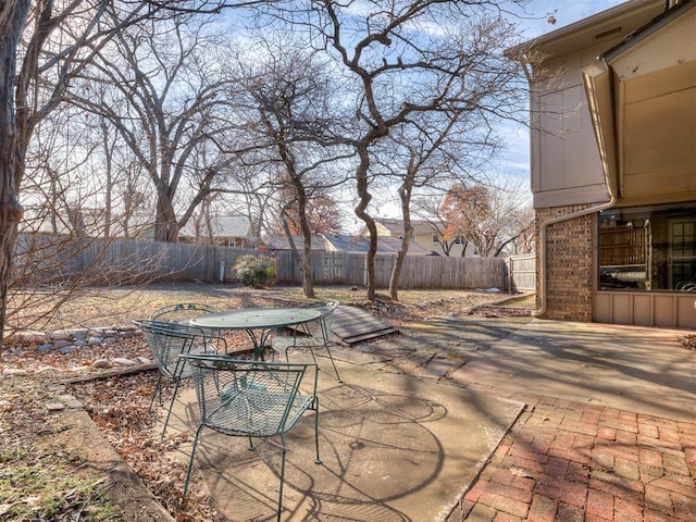 view of patio featuring outdoor dining area and a fenced backyard