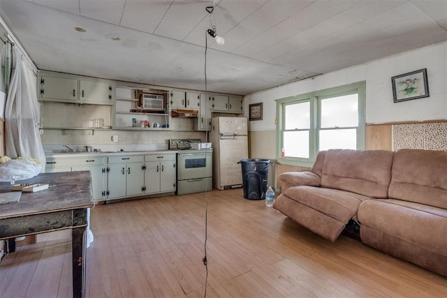 21731 E Fifth St, Hinton, OK 73047 - kitchen featuring a wall mounted air conditioner, white appliances, light hardwood / wood-style flooring, and backsplash