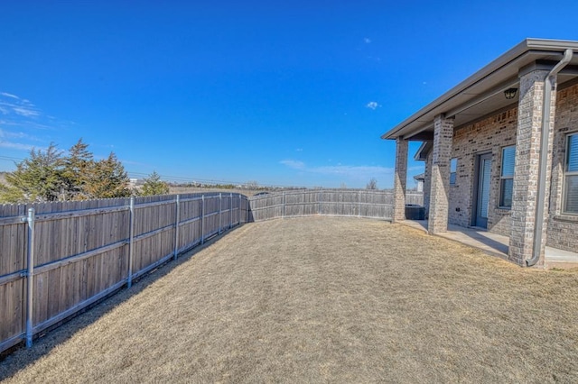 view of yard with a fenced backyard