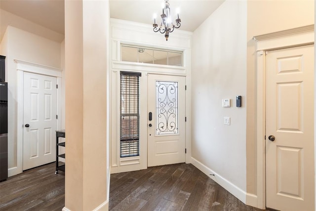 foyer entrance with a chandelier and dark hardwood / wood-style flooring