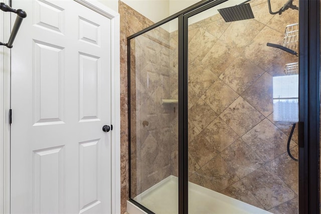 bathroom with a shower with door