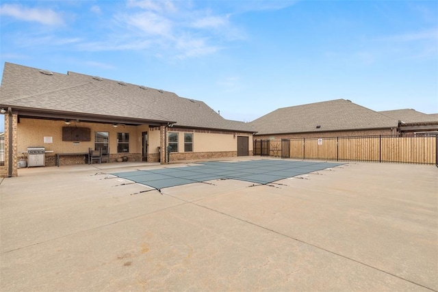 view of pool featuring ceiling fan, area for grilling, and a patio